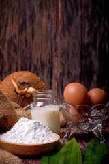 Akok Kedut, egg, coconut, flour , coconut milk and  Pandan leaf on wooden background. Akok Kedut is a traditional dish in Malaysia especially East Coast.