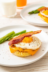fried egg with bacon and cheese on pancake