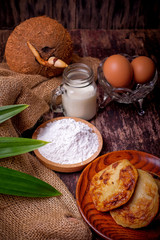 Akok Kedut, egg, coconut, flour , coconut milk and  Pandan leaf on wooden background. Akok Kedut is a traditional dish in Malaysia especially East Coast.