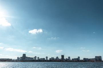 Fototapeta premium Cityscape, view from the river, blue sky.