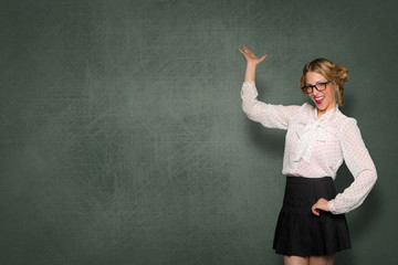 Conceptual business and education, teacher standing by blank blackboard with smile, copy space card