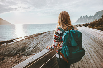 Fototapeta premium Woman tourist enjoying view traveling in Norway with backpack active lifestyle adventure summer vacations voyage outdoor
