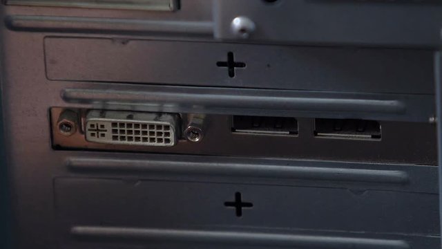 Hand fails to connect VGA cable, outdated wired network, old computer closeup