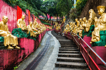 Golden Buddha statues along the stairs leading to the Ten Thousand Buddhas Monastery, Hong Kong,...