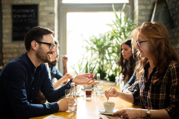 Happy colleagues from work socializing in restaurant