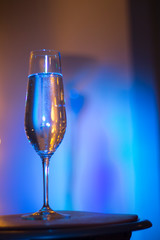 Champagne glass in disco party bar