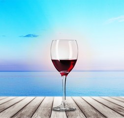 Red wine glass on wooden desk