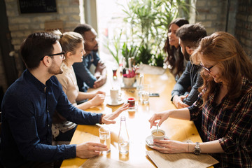 Happy colleagues from work socializing in restaurant