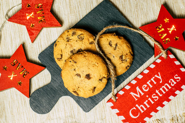 Chocolate chip cookies on a white baking sheet.