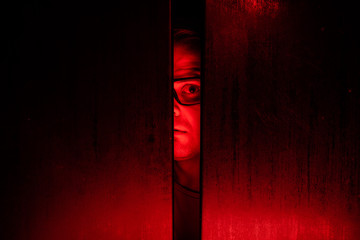 Agoraphobia concept / eye peeking behind the door - 230761121
