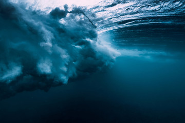 Barrel wave underwater with air bubbles. Ocean in underwater