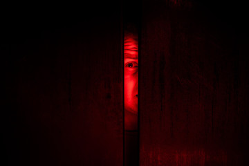 Agoraphobia concept / eye peeking behind the door - 230761352