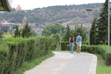 Fototapeta na wymiar Young couple walking in the park
