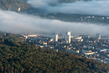 Fototapeta na wymiar vue aérienne de la ville deCaudebec-les-Elbeuf dans la brume en Seine Maritime en France