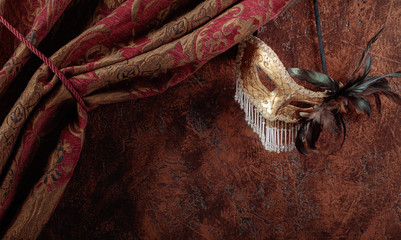 Old masquerade Venetian carnival mask with feathers and rhinestones.