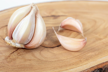 Garlics isolated  on wooden background with shadows