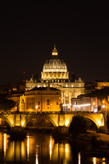 Fototapeta na wymiar Illuminated St. Peter's Basilica and reflections in the Tiber River after sunset in Rome, Italy