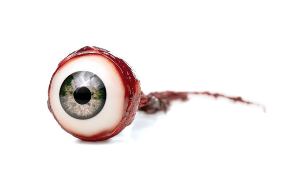 Halloween prop, decoration. Close up of ripped out eyeball isolated on white background