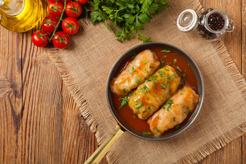 Traditional stuffed cabbage with minced meat and rice, served in a tomato sauce.