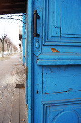                                 Old blue open door and street view