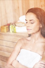 Naklejka premium Young beautiful relaxed woman in sauna