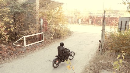 Rider on motorbike on the industrial zone