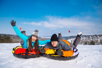 friends having fun. snow tubing. winter activity.