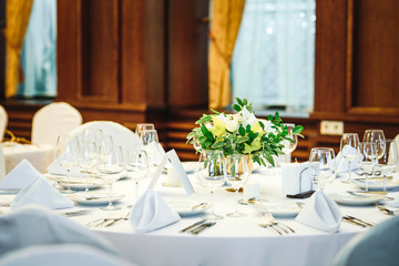 Wedding table set up. Indoor set up of a wedding/party table with  flower decoration