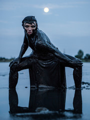 Slender Caucasian Girl Stays Smeared in a Healthy Black Mud in old Firth. Legs set wide apart and...