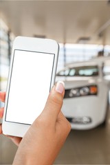 Hand holds phone and car.