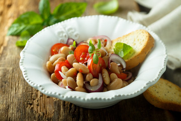White bean salad with cherry tomatoes and red onion