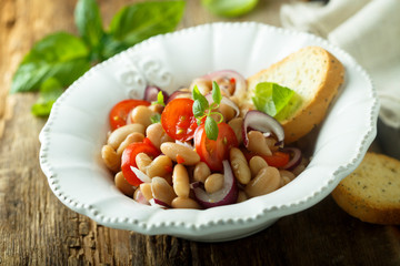 White bean salad with cherry tomatoes and red onion