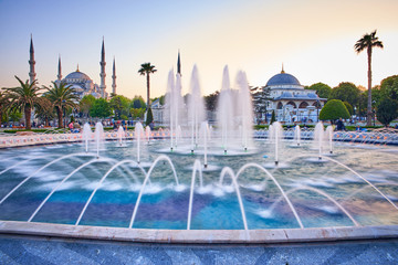 Fototapeta na wymiar Fountain and The Sultan Ahmed Mosque in Istanbul during sunset