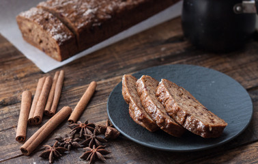 Homemade banana bread with anis star and cinnamon on a dark wooden background