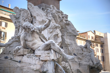 Fototapeta na wymiar Rome, Navona square (Piazza Navona) church of St Agnese and fountain of the four rivers by Bernini. Statue depicting the Rio de la Plata river