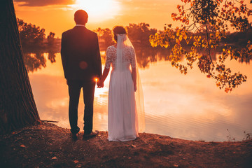 Wedding couple and sunset light, bride and groom, autumn sunset