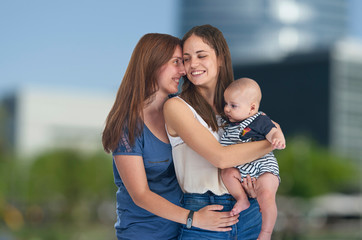 Homosexual family, young lesbian mothers with their baby. Lesbian love