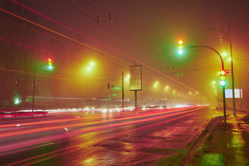traffic light in a foggy night city