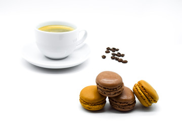 Cup of coffee with macarons and coffee beans isolated on white background