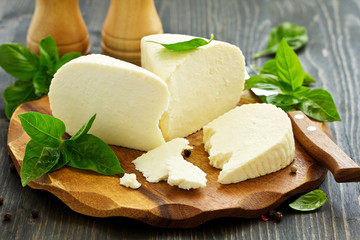 cheese brynza  and garlic on a cutting board.