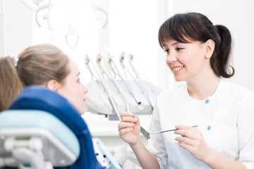Fototapeta premium Dentist treats the patient's teeth in the clinic