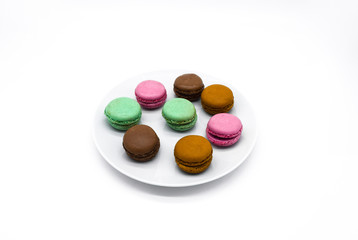 macarons on plate, sweet colorful macarons on white background