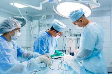 Three doctors the surgeon doing the surgery at the hospital