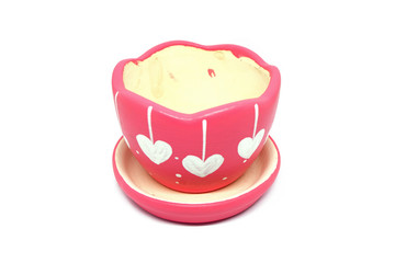 Pink flower pot with white  heart pattern isolated on white background.