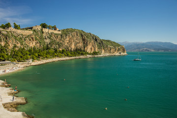 vacation concept of tropic south resort nature place rocks cape and sea bay with vivid colorful water, yachts and swimming people 