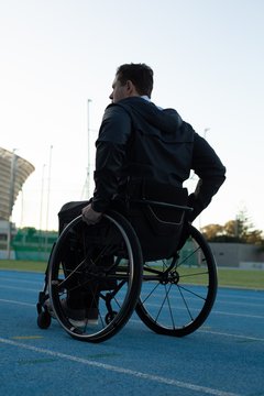 Disabled athletic moving with wheelchair at sports venue