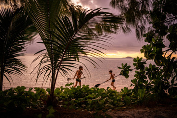 Obraz na płótnie Canvas Children playing during sunset