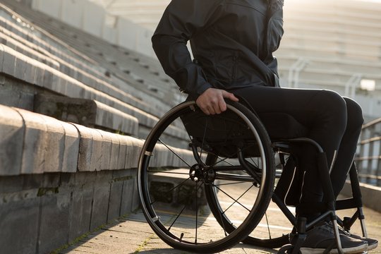 Disabled athletic moving with wheelchair at sports venue