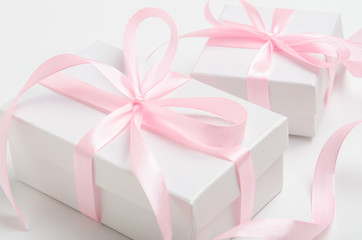 A gift for a woman in white box with a pink ribbon. Congratulations on the holiday, women's day