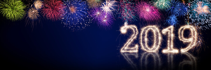 colorful fireworks and bright sparkler pyrotechnic number 2019 happy new year sylvester concept on black blue panorama background